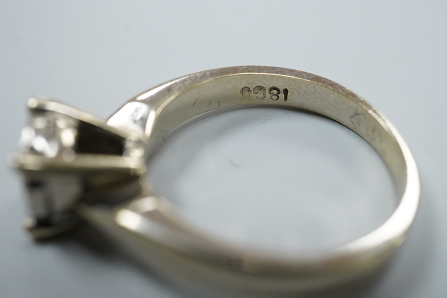 An 18ct and illusion set solitaire diamond ring, the stone weighing approximately 0.30ct, size K, gross weight 4.2 grams.